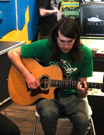 Chris Miller playing acoustic guitar