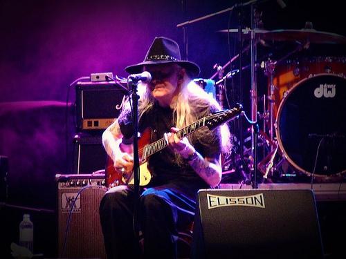 Johnny Winter playing guitar at concert