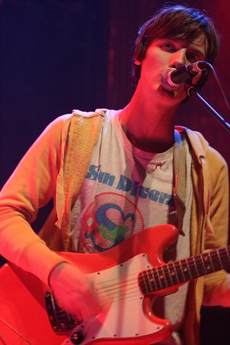 Lockett playing guitar live on stage