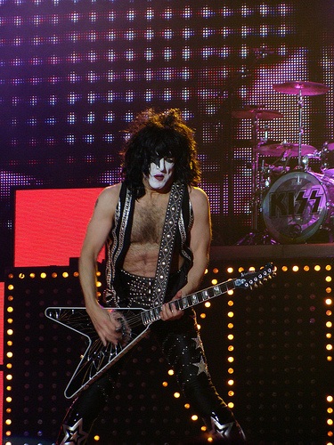 Paul Stanley playing guitar at a concert