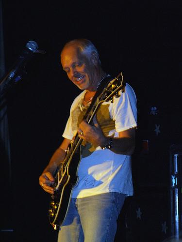 Peter Frampton playing guitar on stage