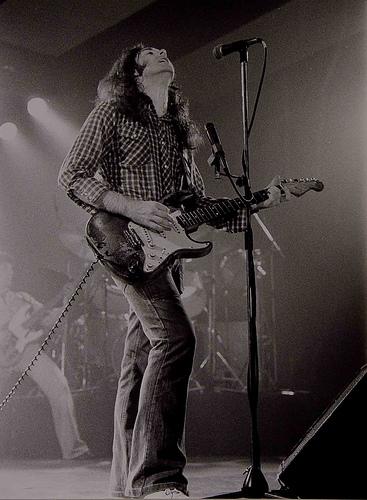 Rory Gallagher playing guitar