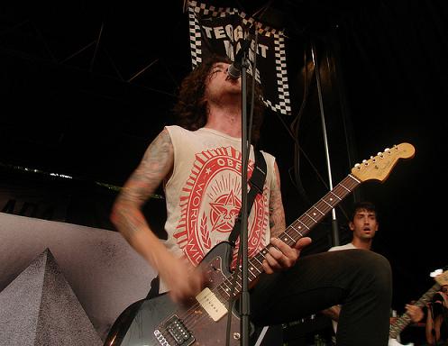 Jeremy DePoyster playing guitar at concert