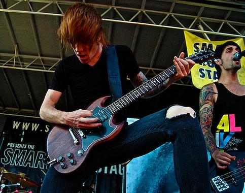 Nick Miller playing guitar live on stage