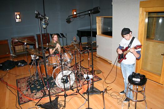 Zach playing guitar in recording studio