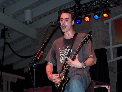 Benjamin playing guitar on stage