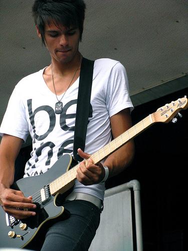 Blake playing guitar with VersaEmerge