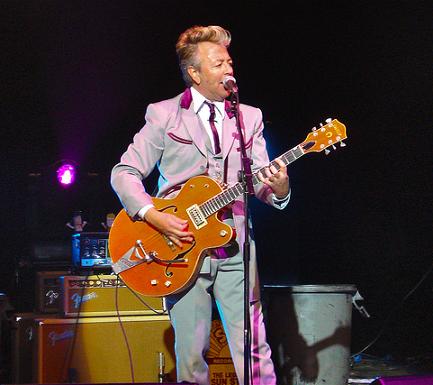 Brian Setzer playing guitar at concert