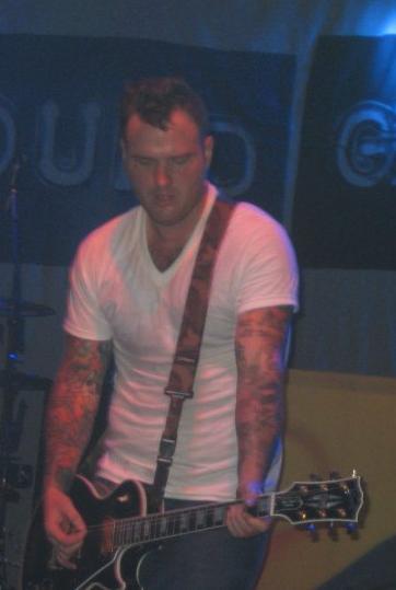 Chad Gilbert playing guitar at a concert