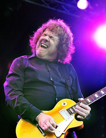 Gary Moore playing guitar on stage