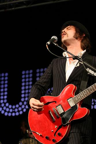 Gaz Coombes playing guitar live on stage