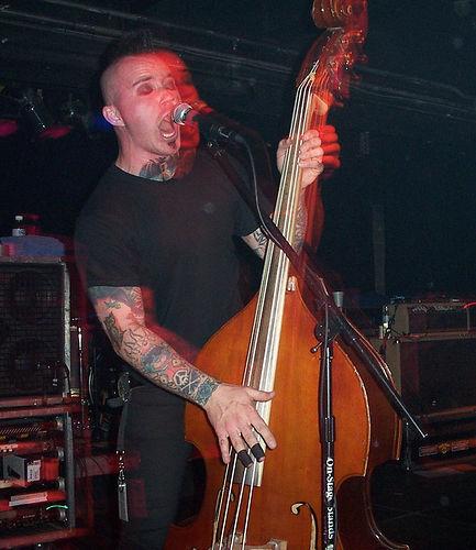 Geoff playing bass on stage