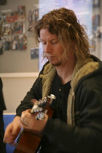 Greg Bradley playing the acoustic guitar