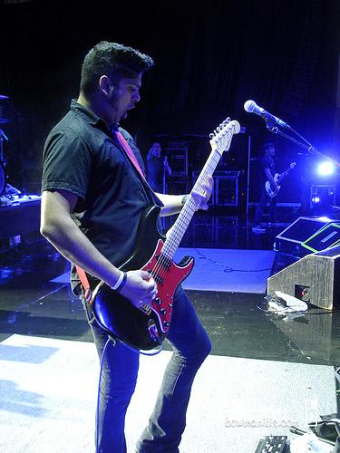 Ian playing guitar on stage