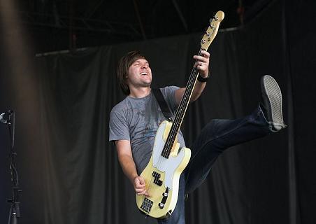 John Warne playing bass guitar