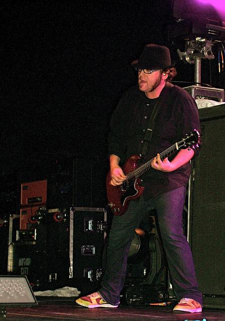 Joshua playing guitar on stage