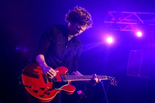 Matt playing guitar live on stage