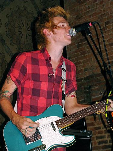 Nick Santino playing guitar at a concert