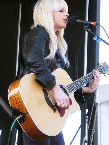 Orianthi playing guitar on stage