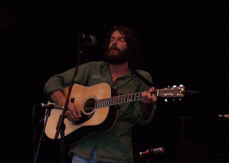 Ray playing guitar on stage