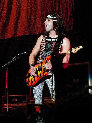 Satchel playing guitar with Steel Panther