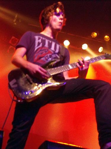 Tom Searle playing guitar at concert